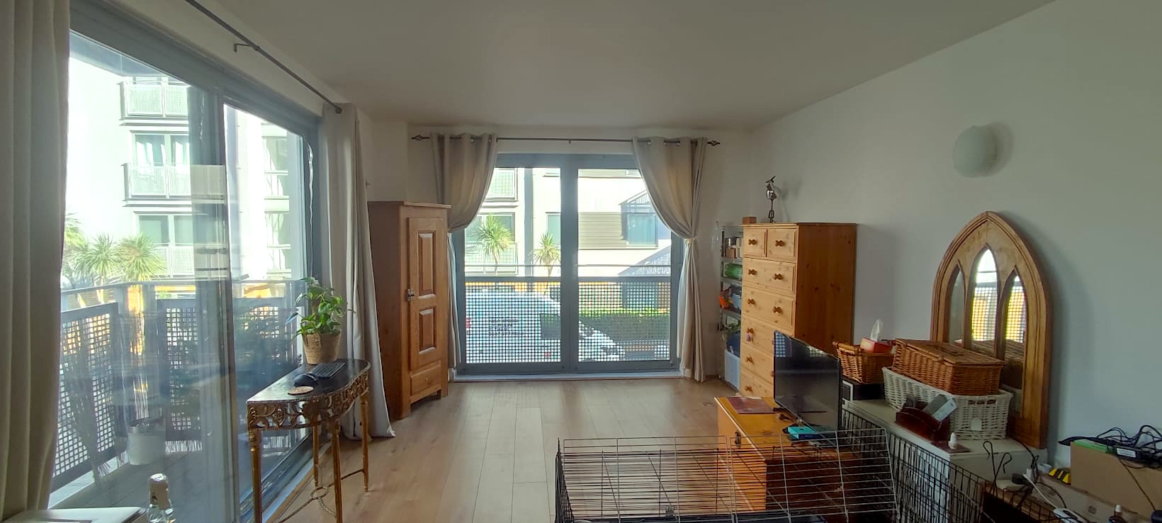 Living room with balcony view and natural light